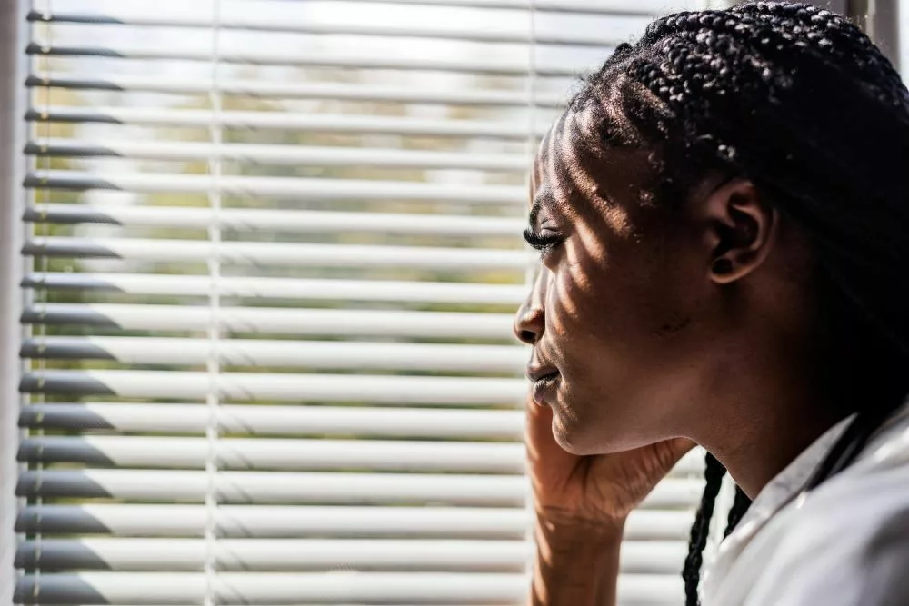 Woman looking outside of a window